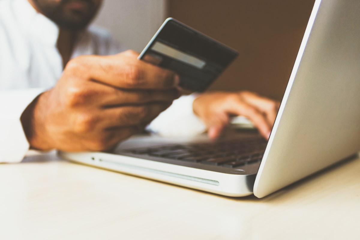 Young Indian professional checking credit card approval on phone