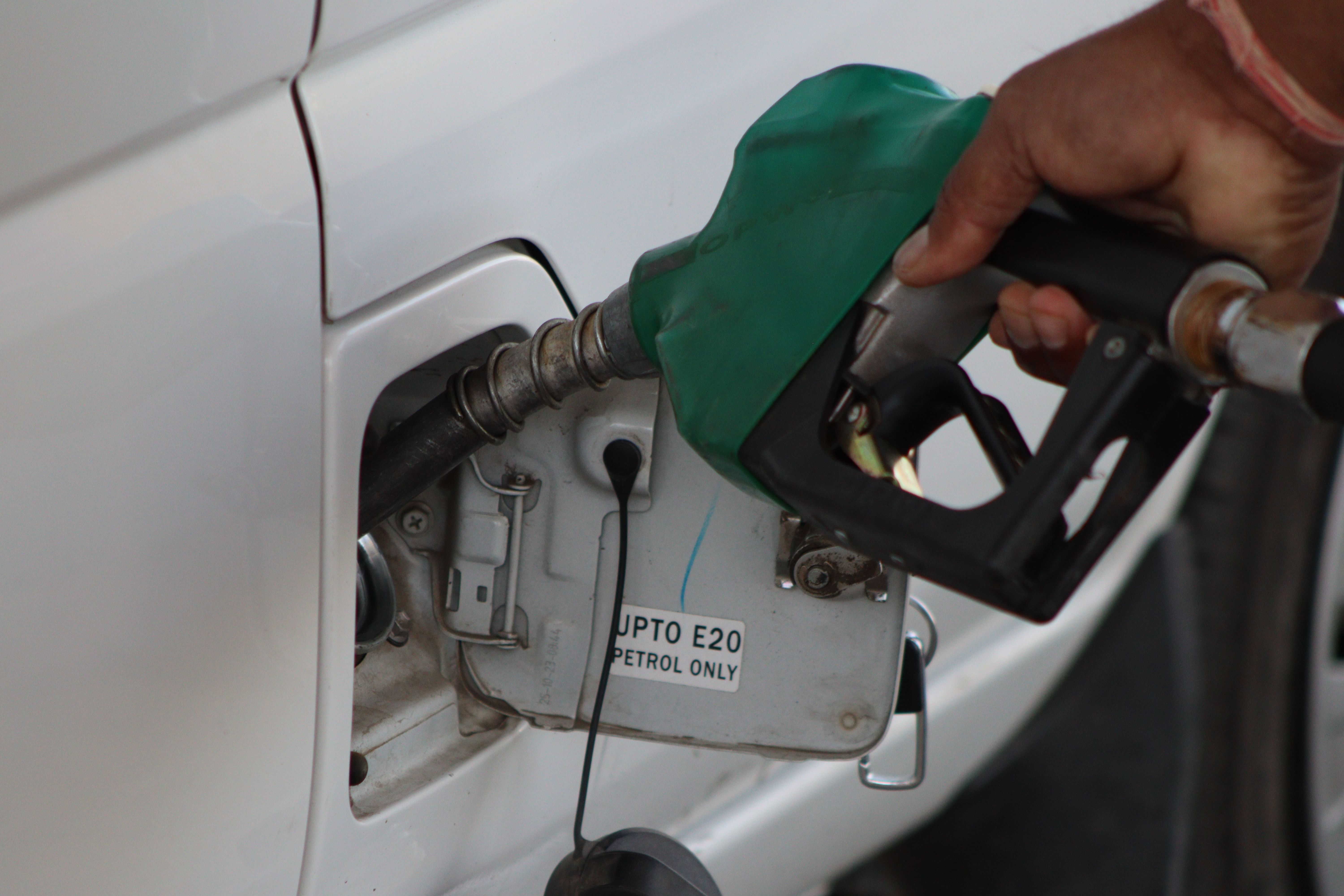Person refuelling car at Indian petrol station