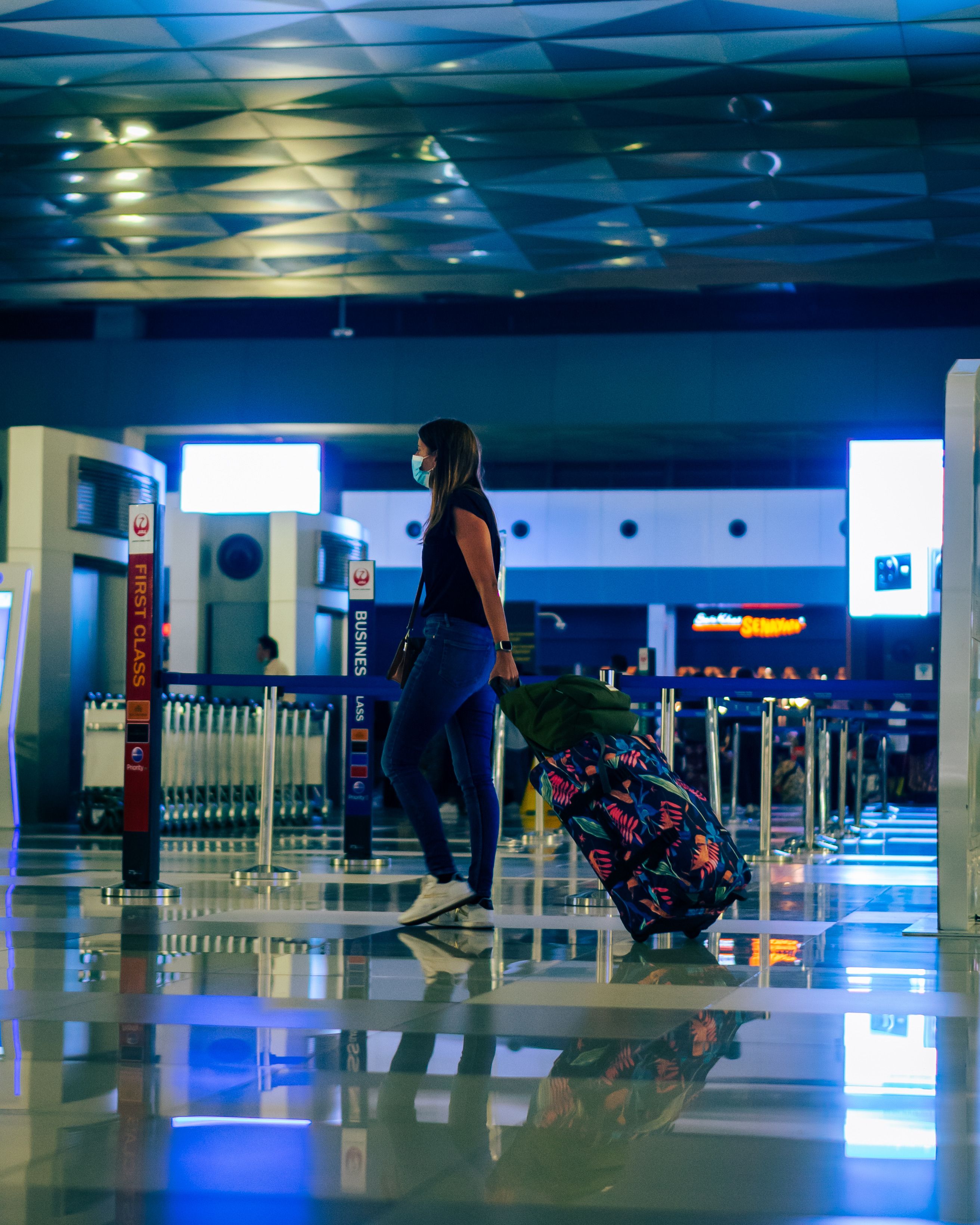 Young traveller with luggage at airport terminal